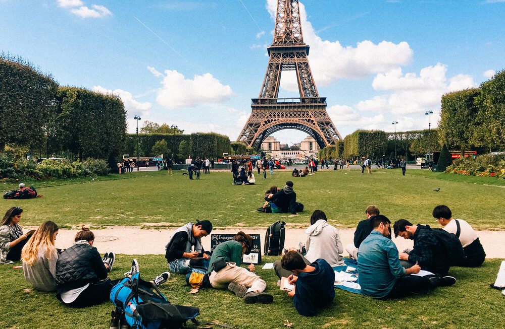 Travelers painting together on the Champ de Mars, Paris